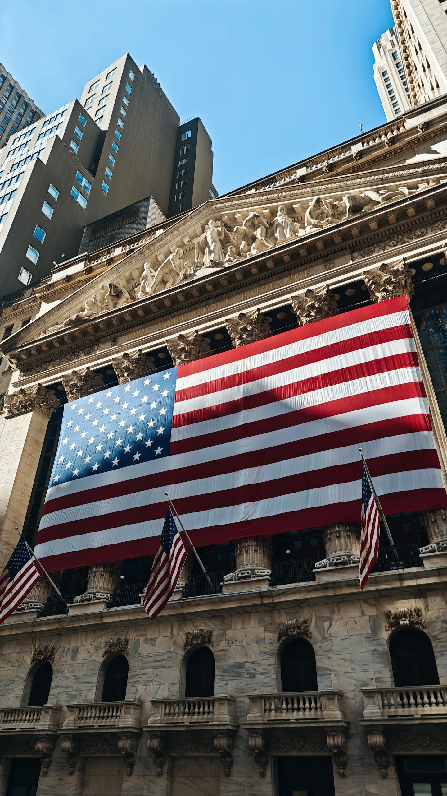 American flag adorning the iconic New York Stock Exchange building facade.
